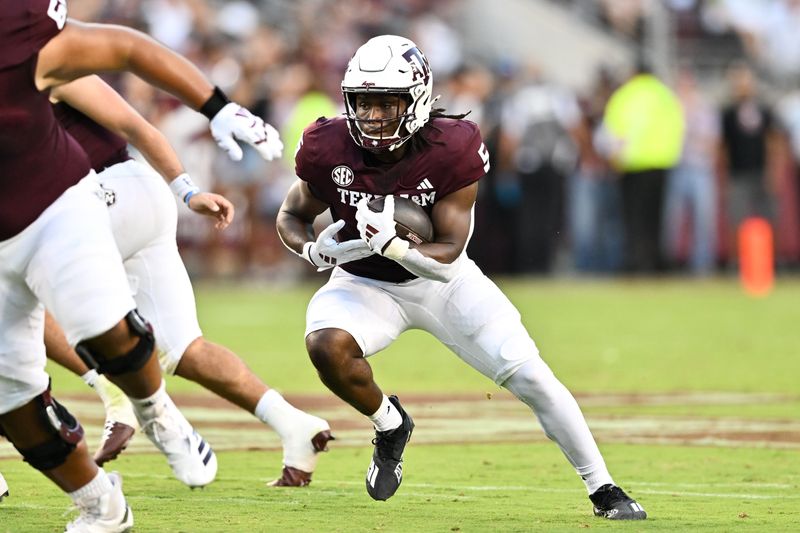 Aug 31, 2024; College Station, Texas, USA; Texas A&M Aggies running back Amari Daniels (5) runs the ball during the first quarter against the Notre Dame Fighting Irish at Kyle Field. Mandatory Credit: Maria Lysaker-USA TODAY Sports