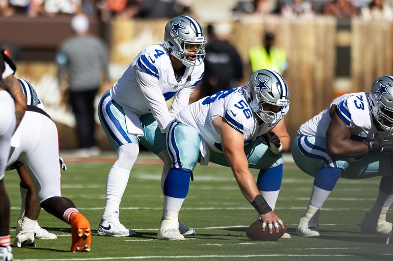 Sep 8, 2024; Cleveland, Ohio, USA; Dallas Cowboys quarterback Dak Prescott (4) lines up behind center Cooper Beebe (56) for the snap during the first quarter against the Cleveland Browns at Huntington Bank Field. Mandatory Credit: Scott Galvin-Imagn Images