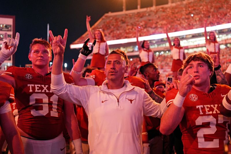 Sep 14, 2024; Austin, Texas, USA; Texas Longhorns head coach Steve Sarkisian stands for the Eyes of Texas with players and fans after a victory over the Texas-San Antonio Roadrunners at Darrell K Royal-Texas Memorial Stadium. Mandatory Credit: Scott Wachter-Imagn Images