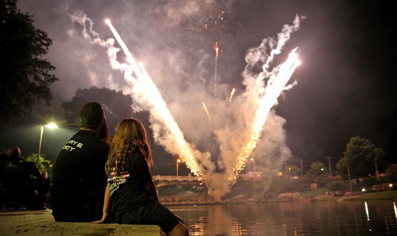 People gather along the Concho River to watch fireworks during the Star Spangled Concert and Fireworks on July 3, 2021.