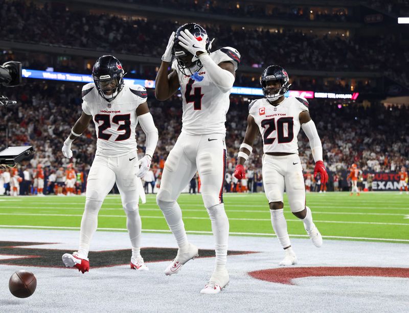 Sep 15, 2024; Houston, Texas, USA; Houston Texans cornerback Kamari Lassiter (4) celebrates his interception against the Chicago Bears in the second half at NRG Stadium. Mandatory Credit: Thomas Shea-Imagn Images