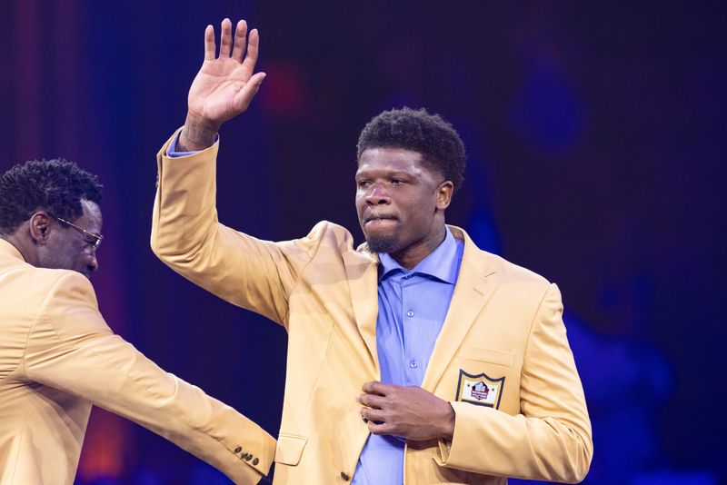 Aug 2, 2024; Canton, OH, USA; Andre Johnson waves to the crowd after receiving his gold jacket at the 2024 Pro Football Hall of Fame Enshrines gold jacket dinner at Canton Memorial Civic Center. Mandatory Credit: Scott Galvin-USA TODAY Sports