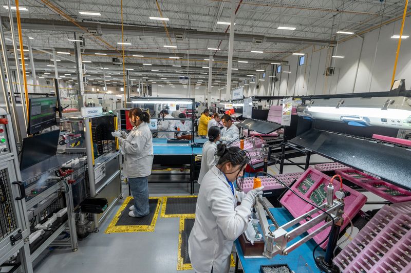 Mexican workers assemble electronics at the Lacroix plant in Ciudad Juarez, Mexico in February 2025. The electronics are used in GMC trucks.