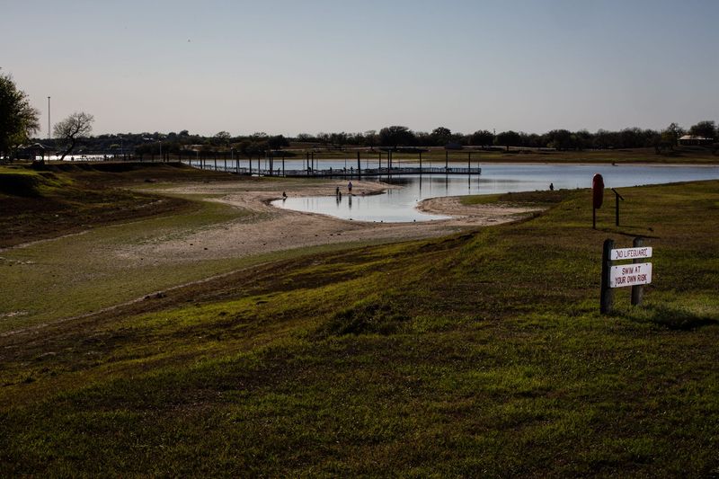 People fish and explore the receding shoreline of Lake Corpus Christi at the state park on Monday, March 11, 2025, in Mathis, Texas.