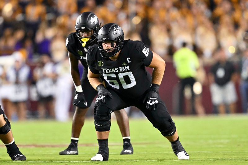 Oct 26, 2024; College Station, Texas, USA; Texas A&M Aggies offensive lineman Trey Zuhn III (60) lines up during the second quarter against the LSU Tigers. The Aggies defeated the Tigers 38-23; at Kyle Field. Mandatory Credit: Maria Lysaker-Imagn Images.