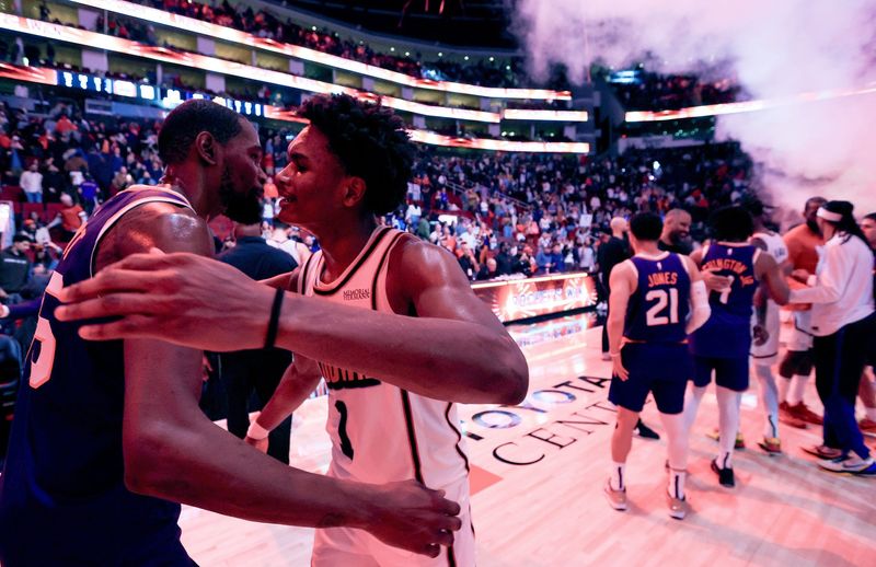 Feb 12, 2025; Houston, Texas, USA; Phoenix Suns forward Kevin Durant (35) hugs Houston Rockets forward Amen Thompson (1) after a game at Toyota Center. Mandatory Credit: Thomas Shea-Imagn Images