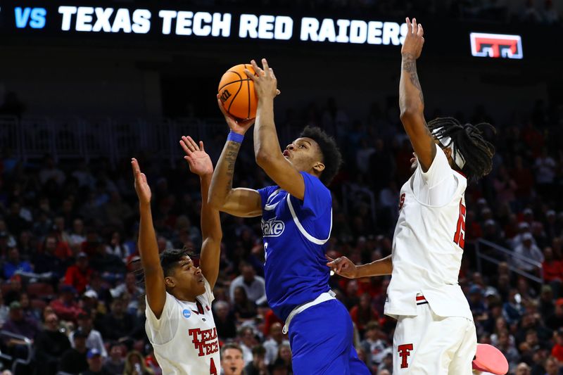 Mar 22, 2025; Wichita, KS, USA; Drake Bulldogs guard Tavion Banks (6) shoots the ball against Texas Tech Red Raiders guard Christian Anderson (4) and forward JT Toppin (15) during the second half at Intrust Bank Arena. Mandatory Credit: Nick Tre. Smith-Imagn Images