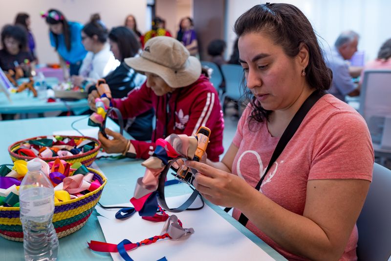 People make their own Mexican doll headband (Diademas Lele) during the grand opening of the Mexican American Culture Center in Downtown El Paso, Texas, on Saturday, March 22, 2025.