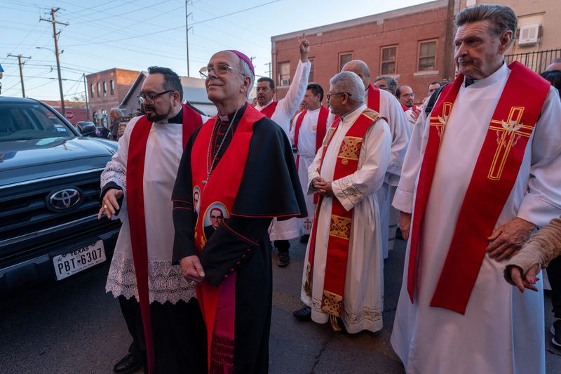 Bishop Mark Seitz, center in black, leads other Catholic clergy march during the "March for Dignity," where hundreds of members of the community rallied in support of immigrants' rights on March 24, 2025 in Downtown El Paso.