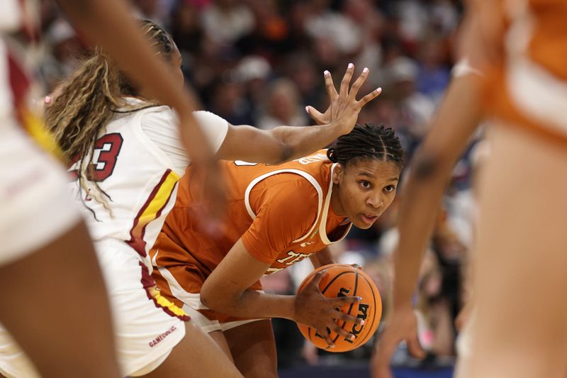 Apr 4, 2025; Tampa, FL, USA; Texas Longhorns forward Madison Booker (35) controls the ball against South Carolina Gamecocks guard Bree Hall (23) during the second quarter in a semifinal of the women's 2025 NCAA tournament at Amalie Arena. Mandatory Credit: Nathan Ray Seebeck-Imagn Images