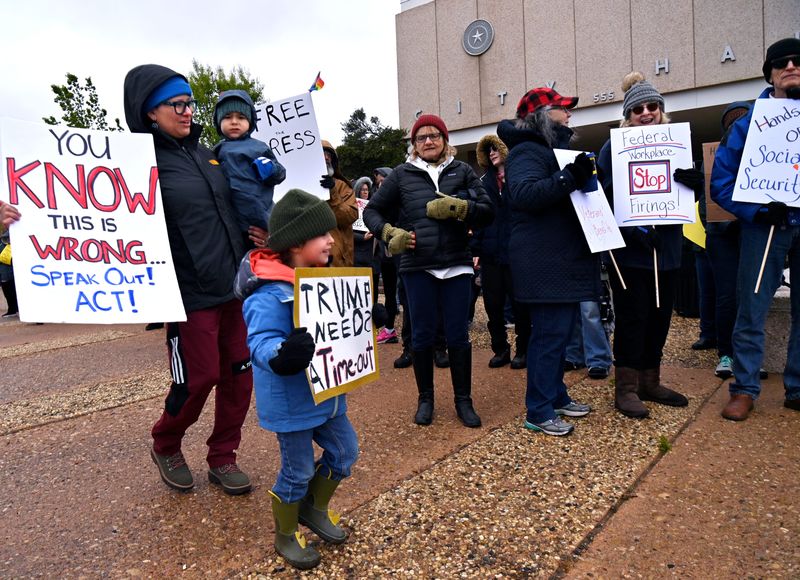 Protestors chant and wave signs during the “Hands Off Abilene” demonstration April 5 outside Abilene City Hall. The protest was part of a larger movement nationwide in opposition to Trump Administration policies that have gutted federal agencies.