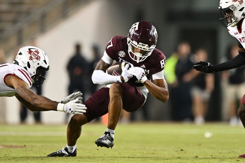 Nov 16, 2024; College Station, Texas, USA; Texas A&M Aggies wide receiver Ashton Bethel-Roman (87) runs the ball during the second half against the New Mexico State Aggies at Kyle Field. Mandatory Credit: Maria Lysaker-Imagn Images