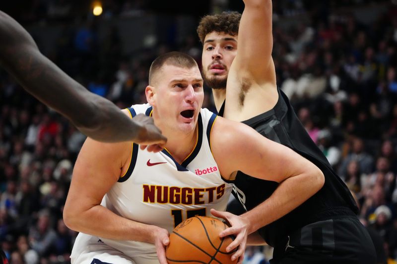 Dec 8, 2023; Denver, Colorado, USA; Denver Nuggets center Nikola Jokic (15) drives past Houston Rockets center Alperen Sengun (28) in the second half at Ball Arena. Mandatory Credit: Ron Chenoy-USA TODAY Sports