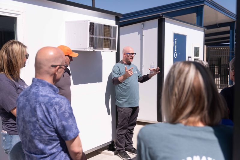 In this April 12, 2025 file photo, Jason Riddlespurger, Amarillo Director of Community Development shows attendees the temporary housing at Transformation Park in Amarillo.