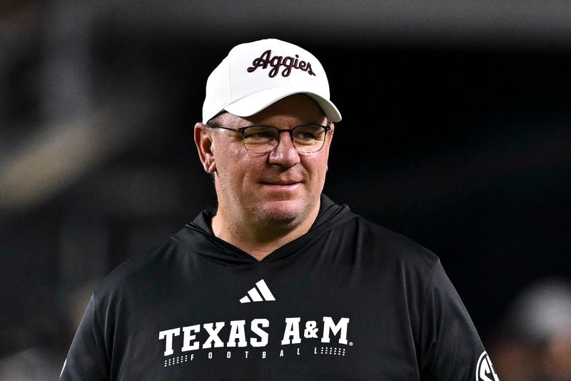 Nov 16, 2024; College Station, Texas, USA; Texas A&M Aggies head coach Mike Elko walks on the field prior to the game against the New Mexico State Aggies at Kyle Field. Mandatory Credit: Maria Lysaker-Imagn Images