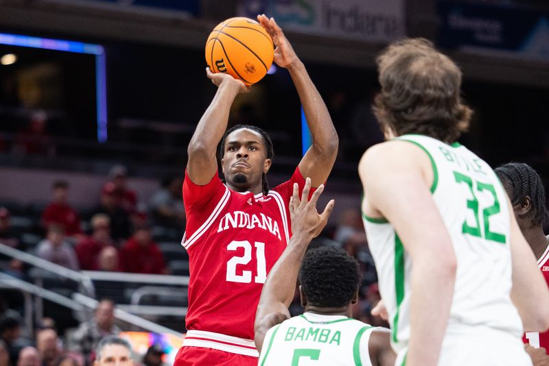 Mar 13, 2025; Indianapolis, IN, USA; Indiana Hoosiers forward Mackenzie Mgbako (21) shoots the ball while Oregon Ducks guard TJ Bamba (5) defends in the first half at Gainbridge Fieldhouse. Mandatory Credit: Trevor Ruszkowski-Imagn Images