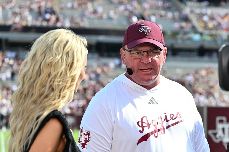 Oct 5, 2024; College Station, Texas, USA; SEC Nation host Laura speaks with Texas A&M Aggies head coach Mike Elko prior to the game between the Texas A&M Aggies and the Missouri Tigers at Kyle Field. Mandatory Credit: Maria Lysaker-Imagn Images.