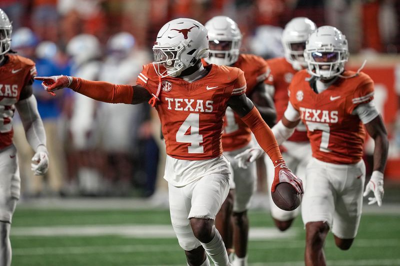 Nov 23, 2024; Austin, Texas, USA; Texas Longhorns defensive back Andrew Mukuba (4) celebrates after a interception against Kentucky Wildcats late in the fourth quarter at Darrell K Royal Texas Memorial Stadium. Mandatory Credit: Ricardo B. Brazziell/USA TODAY Network via Imagn Images