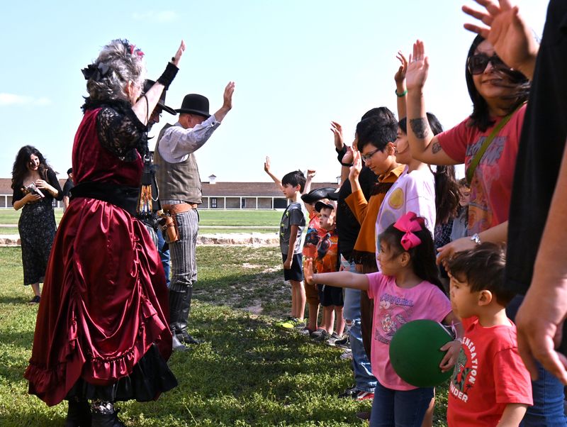 Members of the Concho Cowboy Company lead young audience members in a pledge to be law-abiding citizens after the actors performed their skit, “The Bank Robbery," at Fort Concho in San Angelo on Saturday, April 26, 2025. The fort’s annual Frontier Day showcased aspects of pioneer life in the early days of the Concho Valley.
