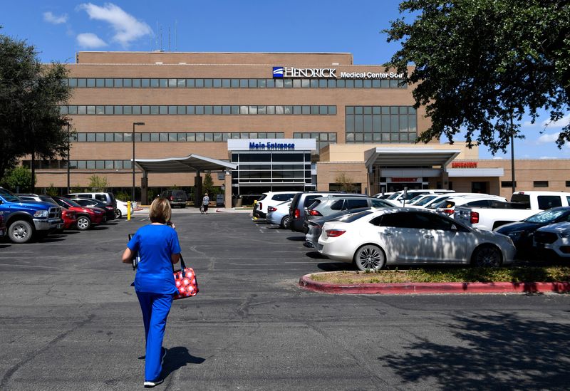 An employee walks toward Hendrick Medical Center South in 2021.