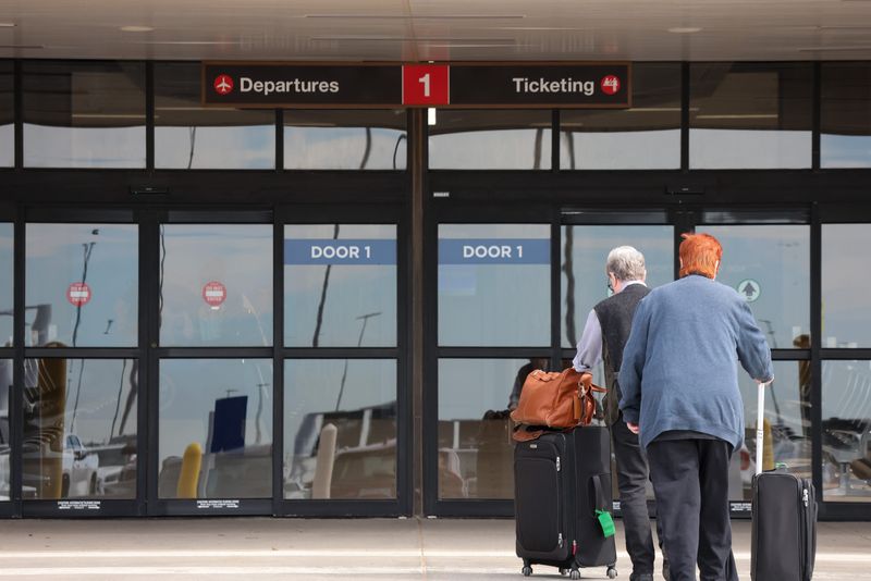 Travels walk towards the airlines ticketing and departure door at the Lubbock Preston Smith International Airport on May 1, 2025 in Lubbock, Texas.