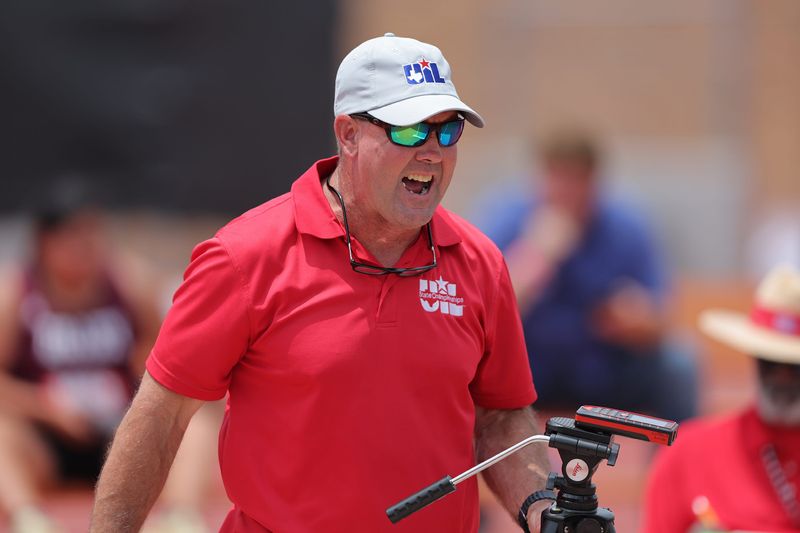 A UIL official calls out shot put distances during the Class 3A UIL State track and field meet on May 1, 2025, at Mike A. Myers Stadium in Austin.