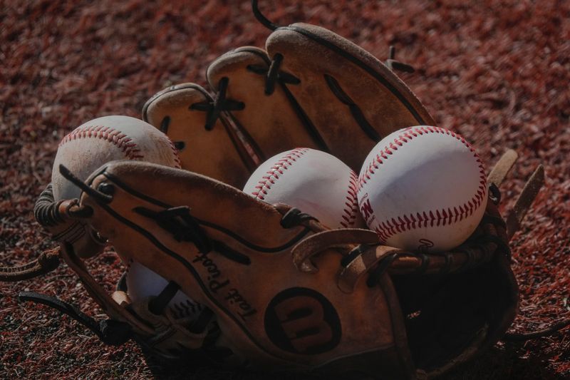 Feb 25, 2025; Tuscaloosa, AL, USA; Baseballs lie in a glove at Sewell-Thomas Stadium.