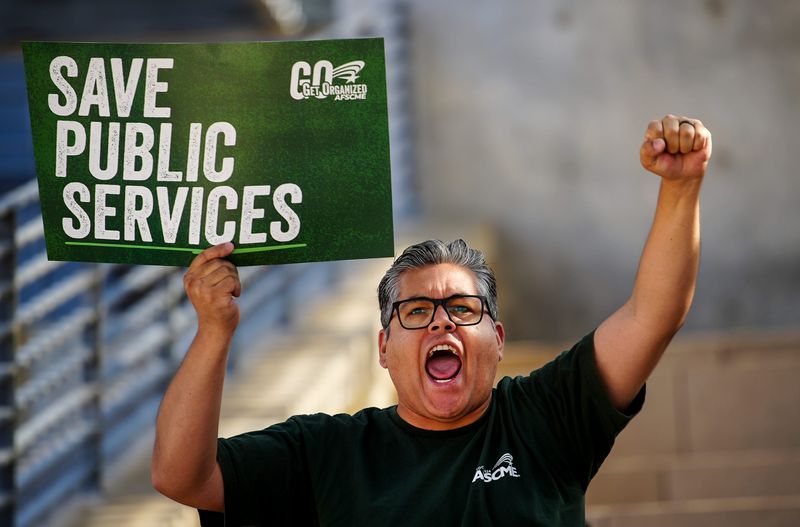 Ben Suddaby joins other Local 1624 of the AFSCME as they gathered in front of Austin City Hall on Wednesday, May 7, 2025 to protest against millions of dollars in federal funding cuts for public health programs.