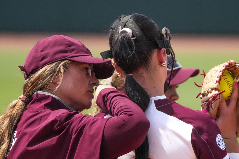 Texas A&M head coach Trisha Ford talks to pitcher Sydney Lessentine (7) during the NCAA D1 Softball Tournament Regional against Saint Francis University at Davis Diamond at Texas A&M University on Friday, May 16, 2025 in College Station, Texas.