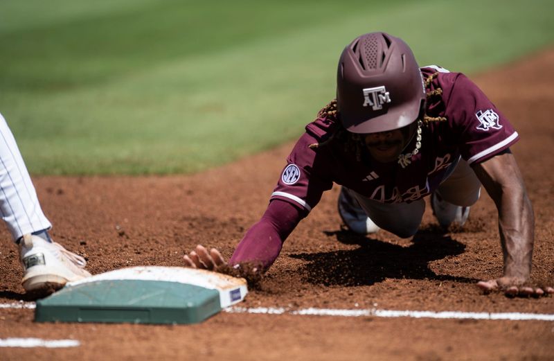Texas A&M Aggies' Terrence Kiel II (3) dives safely into first base as Auburn Tigers take on Texas A&M Aggies during the SEC baseball tournament at Hoover Met in Birmingham, Ala., on Thursday, May 22, 2025.