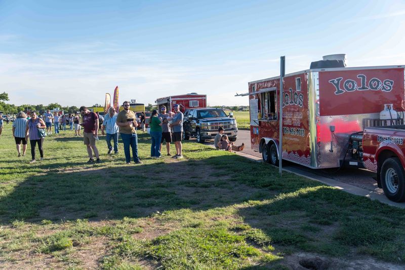 In this file photo, crowds line up for bites from Yolos and other local vendors during the 2025 Battle of the Bites competition at John Stiff Park in Amarillo. The event featured more than 25 food trucks and drew thousands of attendees.