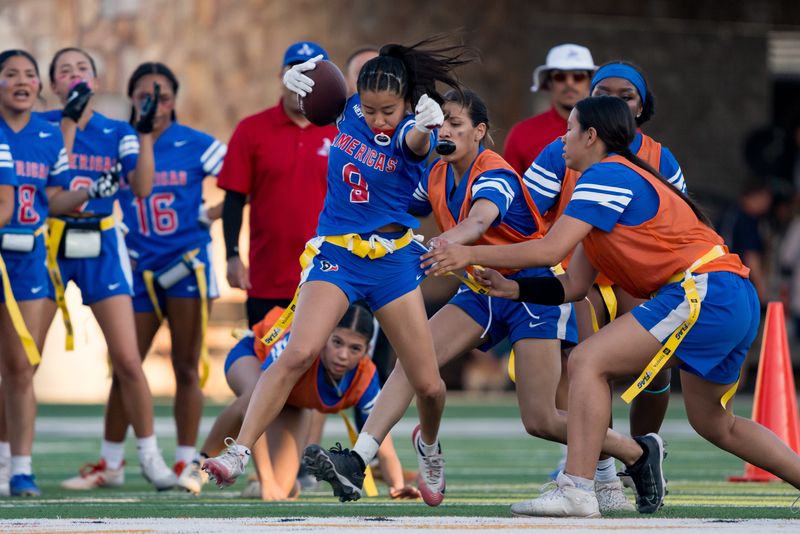 Americas’ Jimena Garcia (9) runs the ball during the inaugural flag football championship game against Harmony at SAC II on May 22, 2025.