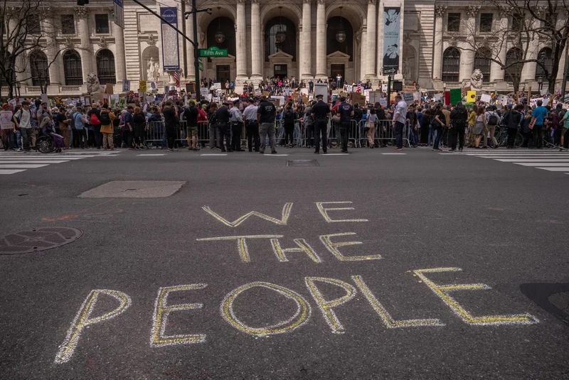 A "Protect Migrants, Protect the Planet" protest is held April 19, 2025, in New York City as part of a nationwide effort denouncing President Donald Trump's "hostile takeover" of the government.