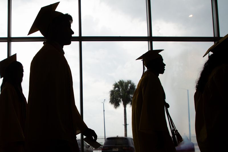 Seniors walk down a hallway to an arena before Miller High School's graduation at American Bank Center in Corpus Christi, Texas, on May 30, 2025.