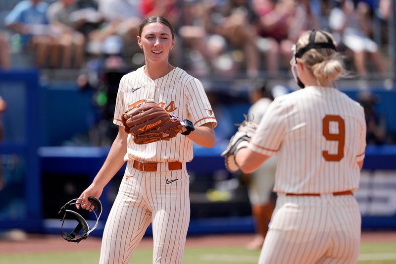 Texas pitcher Teagan Kavan (17) celebrates with infielder Joley Mitchell (9) after an out during a Women's College World Series softball game between the University of Oklahoma Sooners (OU) and the Texas Longhorns at Devon Park in Oklahoma City, Saturday, May 31, 2025. Texas won 4-2.