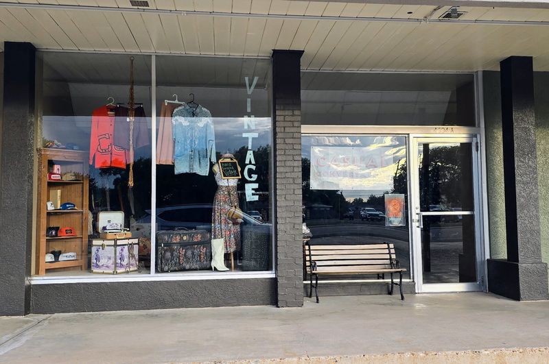 The storefront of Casual Conversation displays colorful vintage outfits and signage, drawing attention on South Washington Street.