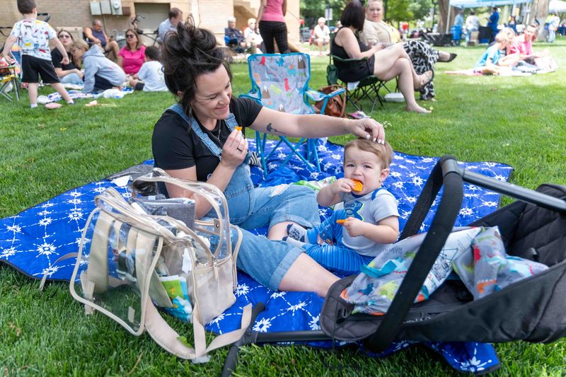Lindsey Oxford shares a lighthearted moment with her son Bennett while enjoying Popsicles on the courthouse lawn during High Noon on the Square. The weekly summer series features live music, food, and family fun in downtown Amarillo.