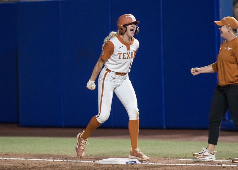 Jun 4, 2025; Oklahoma City, OK, USA; Texas Longhorns utility Reese Atwood (14) yells after hitting an intentional walk pitch for a single and driving in two runs in the sixth inning against the Texas Tech Red Raiders during game one of the NCAA Softball Women's College World Series finals at Devon Park. Mandatory Credit: Brett Rojo-Imagn Images