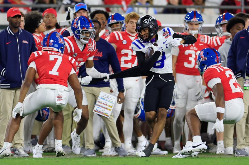 Duke Blue Devils wide receiver Jordan Moore (8) has his jersey ripped by Mississippi Rebels cornerback Chris Graves Jr. (32) as he is forced out of bounds during the third quarter of the TaxSlayer Gator Bowl Thursday, Jan. 2, 2025 at EverBank Stadium in Jacksonville, Fla. Ole Miss defeated Duke 52-20. [Corey Perrine/Florida Times-Union]