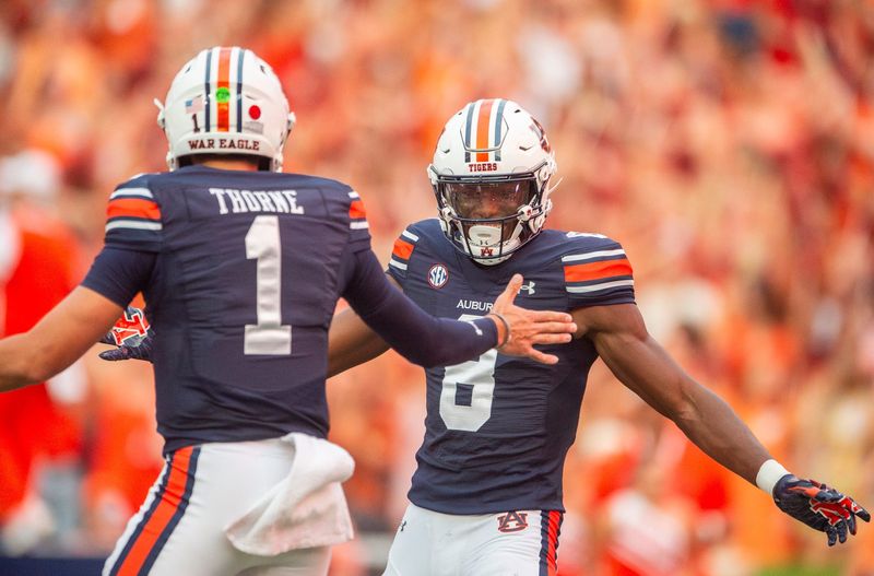 Auburn Tigers quarterback Payton Thorne (1) and Cam Coleman (8) celebrate their touchdown connection as Auburn Tigers takes on Alabama A&M Bulldogs at Jordan-Hare Stadium in Auburn, Ala., on Saturday, Aug. 31, 2024. Auburn Tigers lead Alabama A&M Bulldogs 52-3 at halftime.