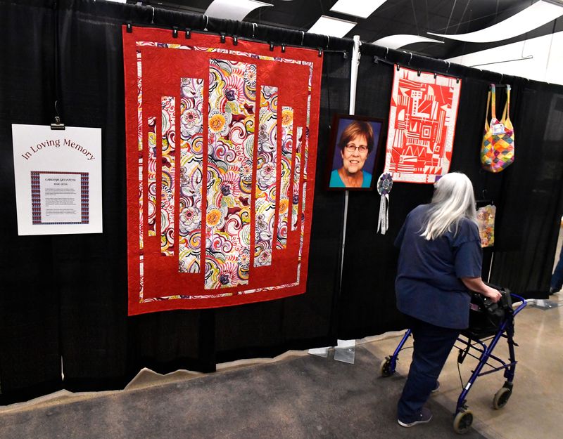 The Stars over Abilene Quilt Show will be returning to the Abilene Convention Center on June 5-6, 2026. A visitor walks past a memorial to Carolyn Griffith, a longtime member of the Abilene Quilters Guild who died in 2024, during Saturday’s 31st Regional Stars over Abilene Quilt Show at the Abilene Convention Center June 7, 2025.