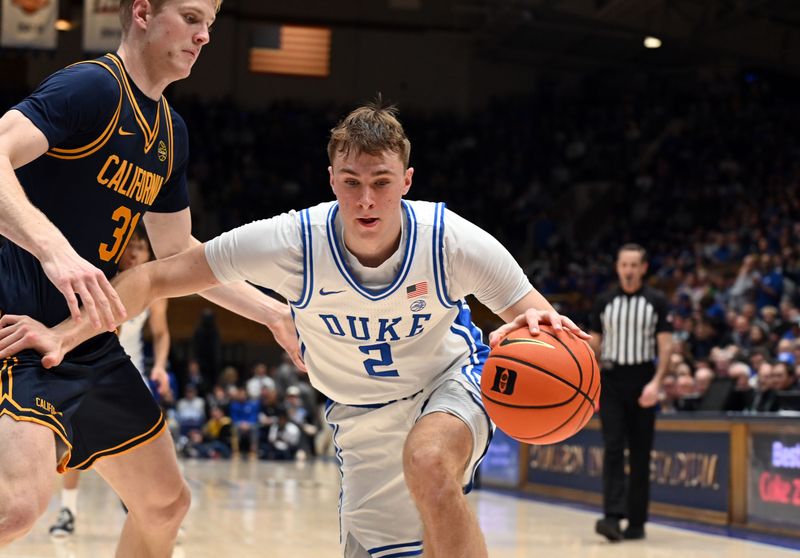 Feb 12, 2025; Durham, North Carolina, USA; Duke Blue Devils forward Cooper Flagg (2) controls the ball in front of California Golden Bears forward Rytis Petraitis (31) during the second half at Cameron Indoor Stadium. Mandatory Credit: Rob Kinnan-Imagn Images