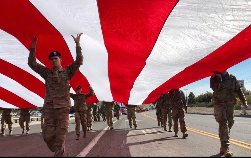 Nov. 11, 2018: Soldiers of the 4th Battalion, 17th Infantry Regiment, 1st Brigade Combat Team of the 1st Armored Division at Fort Bliss carry a giant U.S. flag along Diana Drive to be hoisted at half-staff over Old Glory Memorial during the 2018 Northeast Veteran's Day.