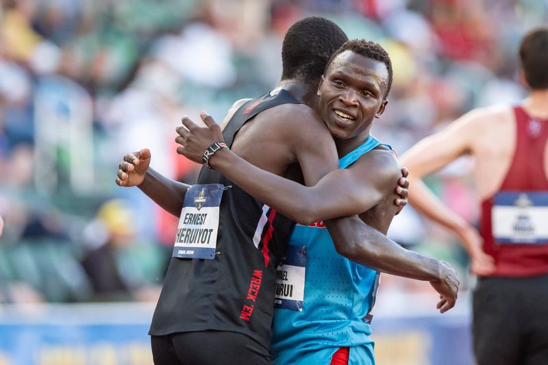 New Mexico’s Ishmael Kipkurui, right, embraces Texas Tech’s Ernest Cheruiyot after winning the men’s 10,000 meters on day one of the NCAA Outdoor Track and Field Championships on June 11, 2025, at Hayward Field in Eugene.