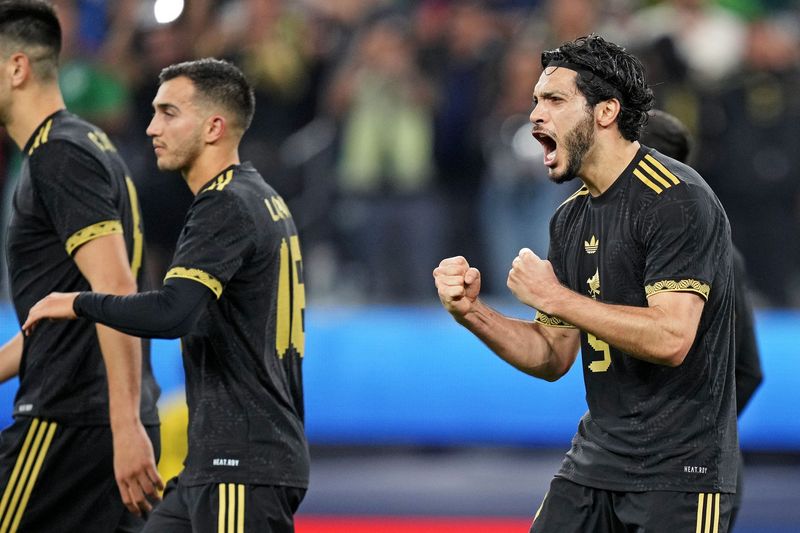 Mexico forward Raul Jimenez (9) celebrates after scoring a goal on a penalty kick during the second half against Mexico during the Concacaf Nations League final at SoFi Stadium.