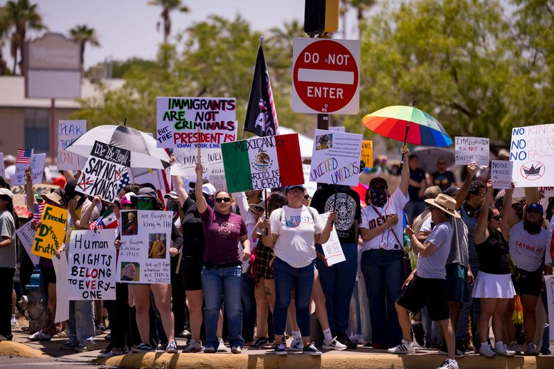 Protesters in El Paso held signs and American flags during a No Kings demonstration at Edgemere Park on Saturday, June 14, 2025. The event was part of a national movement opposing authoritarianism and recent immigration enforcement actions.