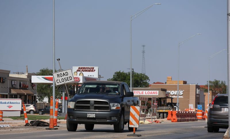Cars pass by road construction on Texas Department of Transportation's 19th Street project near University Avenue on June 14, 2025 in Lubbock, Texas.