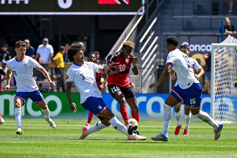 Trinidad and Tobago midfielder Kevin Molino (10), USMNT defender Chris Richards (3), and USMNT defender Alex Freeman (16) all lunge for the ball during a group stage match of the 2025 Gold Cup at PayPal Park.
