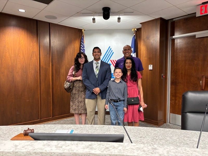 Miguel Espinoza poses with his girlfriend and family after being sworn in Monday at City Hall as the newest member of the Abilene City Council.