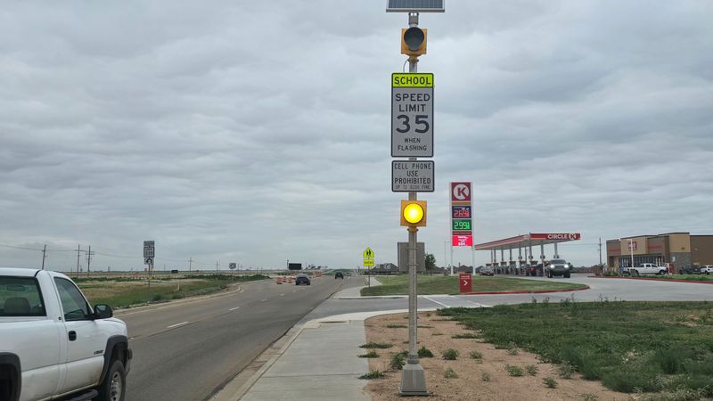 A flashing yellow light signals a 35 mph school zone speed limit on Loop 335 near Arden Road and West Plains High School on June 18.